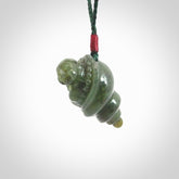 This photo shows a Buddha pendant hand carved in New Zealand Jade. It is provided with an adjustable manuka green cord.